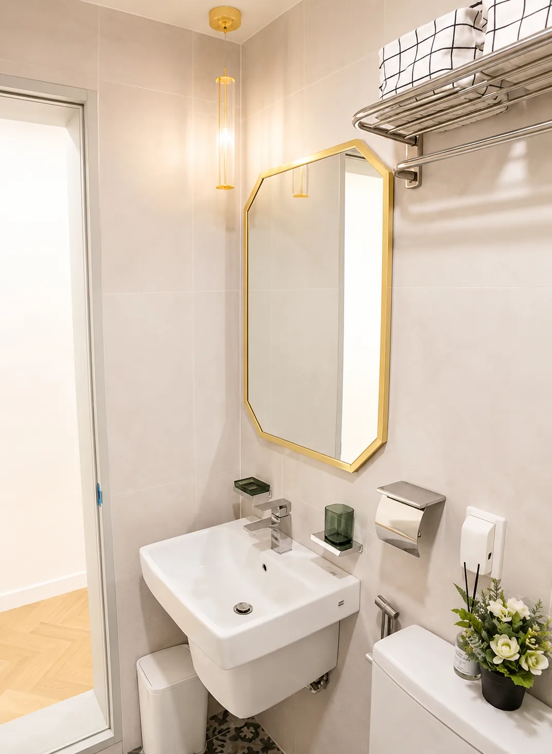 Bathroom with gold-framed mirror