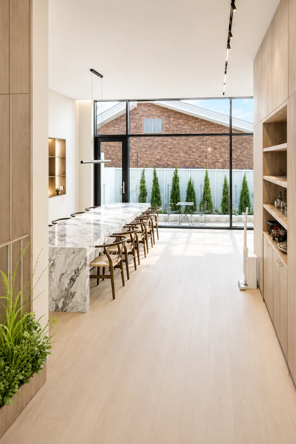 Dining area with long table and terrace view