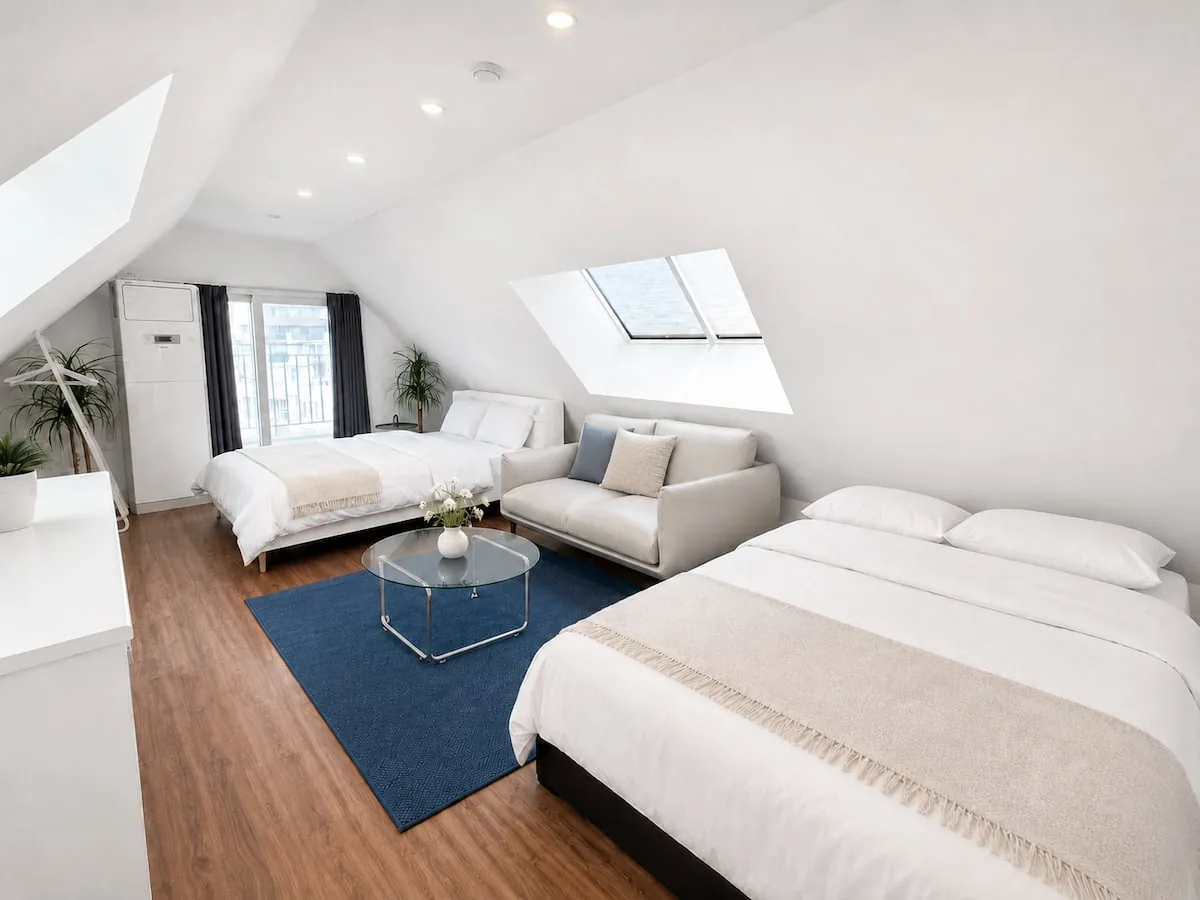Upstairs room with skylights and sofa
