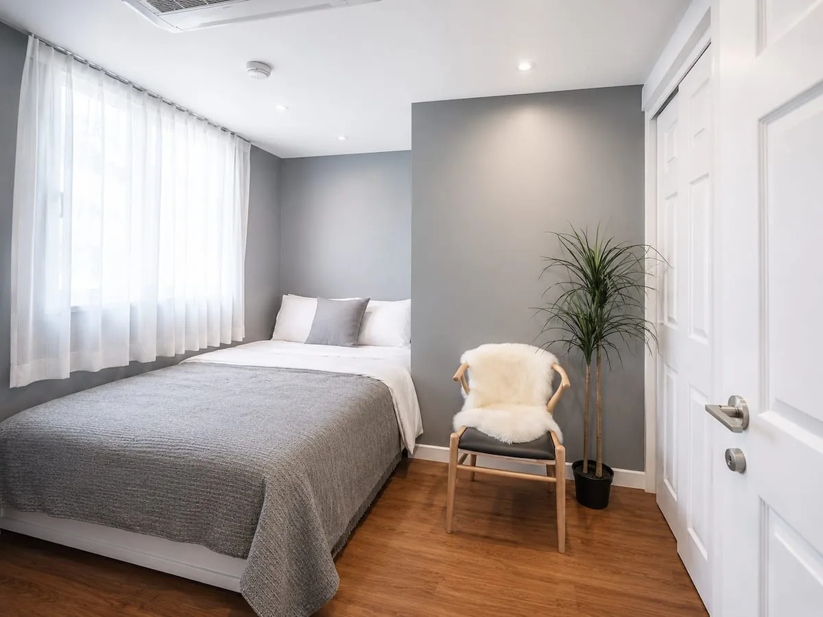 Bedroom with queen bed and chair